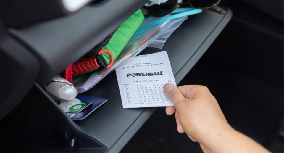 Winning Powerball ticket inside car glovebox