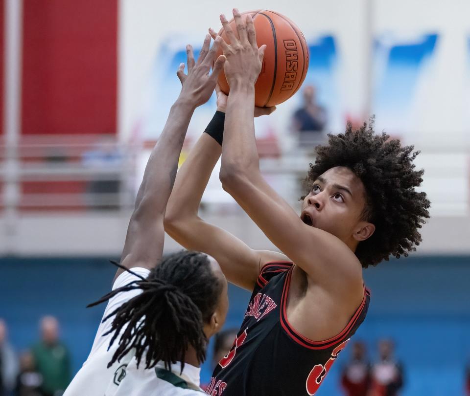 McKinley’s Reed Sims Jr. shoots over GlenOak’s Jaylen McElroy during a district semifinal, Thursday, March 7, 2024.