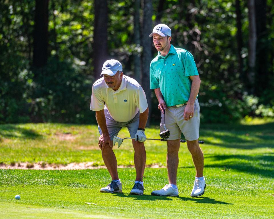 David and Kyle Pelletier study the green on Hole 8 at the Fourball Tournament hosted by Country Club of New Bedford.