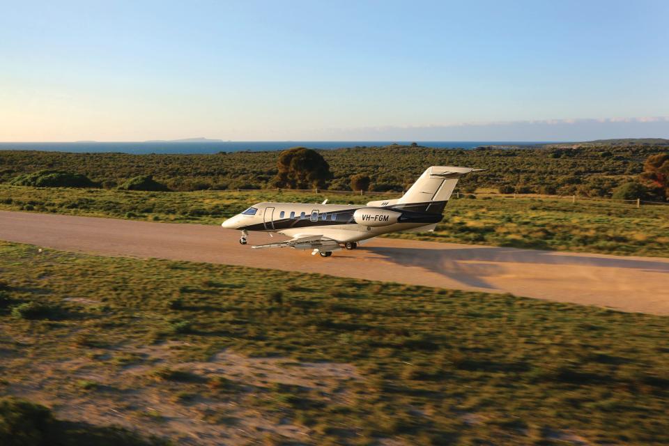 A Pilatus PC-24  landing on an unpaved runway