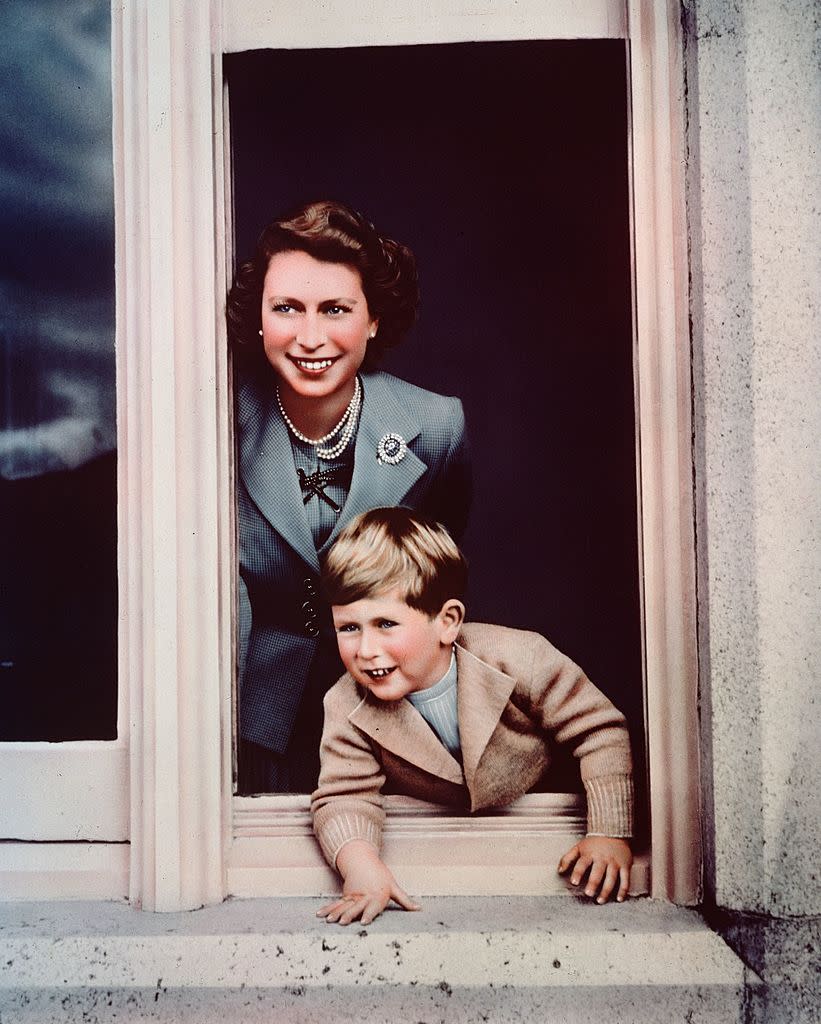 Prince Charles and his mother looking out of a window at Balmoral in 1952. (Photo by Lisa Sheridan/Studio Lisa/Hulton Archive/Getty Images)
