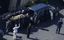 The casket bearing the remains of Muhammad Ali is loaded into a hearse at the A D Porter & Sons funeral home during the funeral procession for the three-time heavyweight boxing champion in Louisville, Kentucky, U.S., June 10, 2016. REUTERS/Adrees Latif