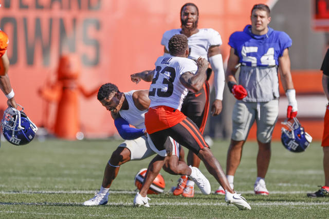 Cleveland Browns defensive end Porter Gustin (97) warms up next to