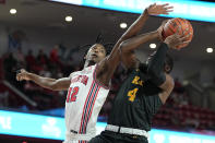 Houston guard Tramon Mark (12) fouls Norfolk State guard Joe Bryant Jr. (4) during the first half of an NCAA college basketball game, Tuesday, Nov. 29, 2022, in Houston. (AP Photo/Kevin M. Cox)
