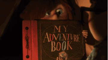 GIF of a little girl showing her "adventure book"