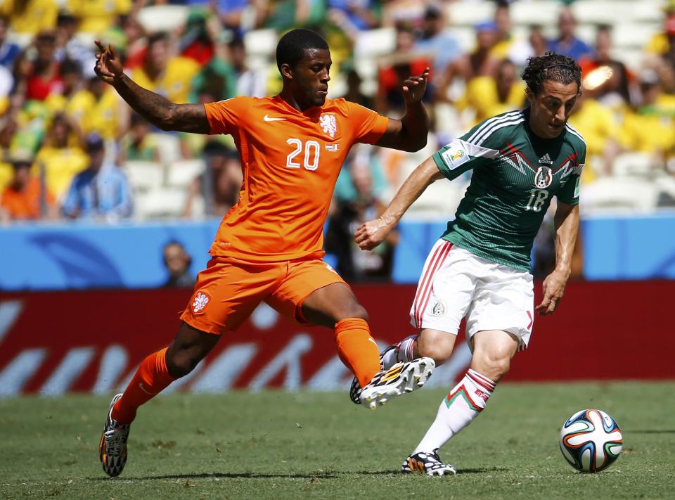 Mexico's Andres Guardado fights for the ball against Georginio Wijnaldum of the Netherlands during their 2014 World Cup round of 16 game at the Castelao arena in Fortaleza