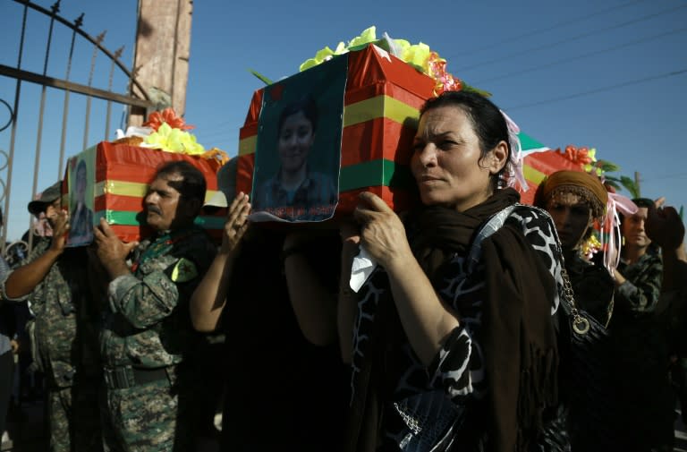 Syrian-Kurdish women carry the coffin of a female fighter in Qamishli on July 3, 2016, during the funeral of eight fighters killed battling IS jihadists in Manbij