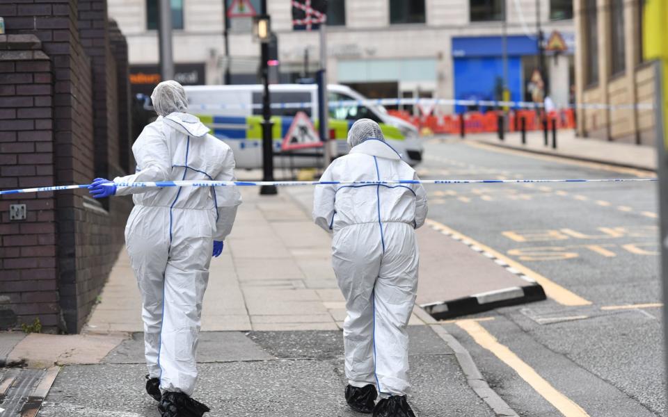 Two police forensics officers enter the cordoned area in Livery Street in Birmingham after a number of people were stabbed in the city centre. -  Jacob King/PA Wire