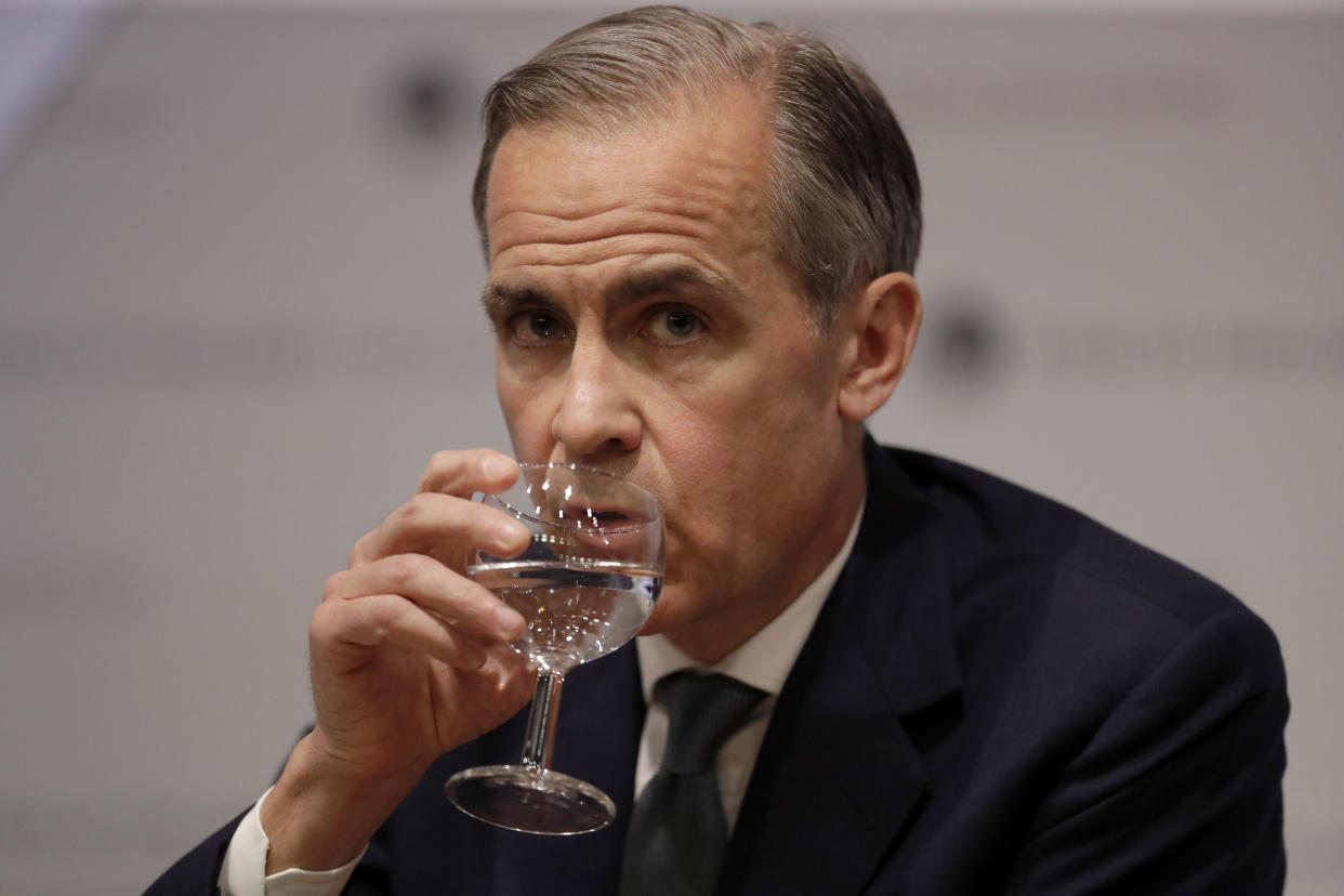 Mark Carney the Governor of the Bank of England sips water during an Inflation Report Press Conference at the Bank of England in the City of London, Thursday, May 2, 2019. (AP Photo/Matt Dunham, Pool)
