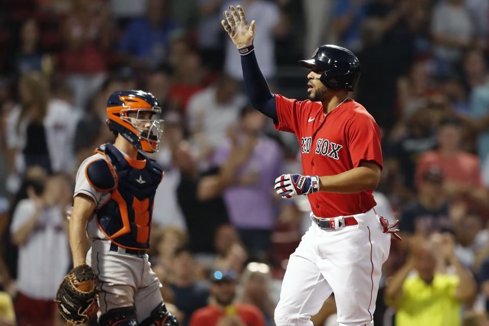 Boston Red Sox's Xander Bogaerts, right, celebrates his solo home run in front of Houston Astros' Garrett Stubbs during the fourth inning of a baseball game, Wednesday, June 9, 2021, in Boston. (AP Photo/Michael Dwyer)