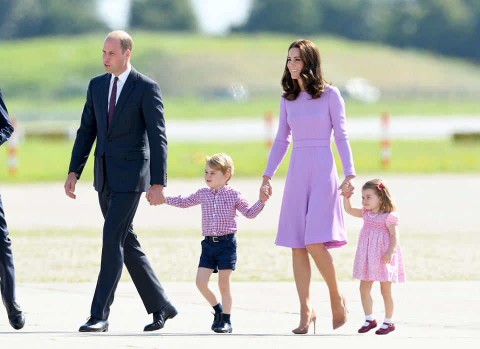 Kate Middleton, Prince William, and their two children Prince George and Princess Charlotte, in shades of purple. (Photo: Getty Images)