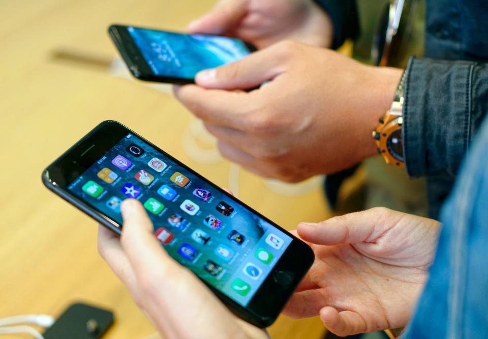 Customers check out the new Apple iPhone 7 at the Apple Store at the Grove in Los Angeles on Sept. 16, 2016.