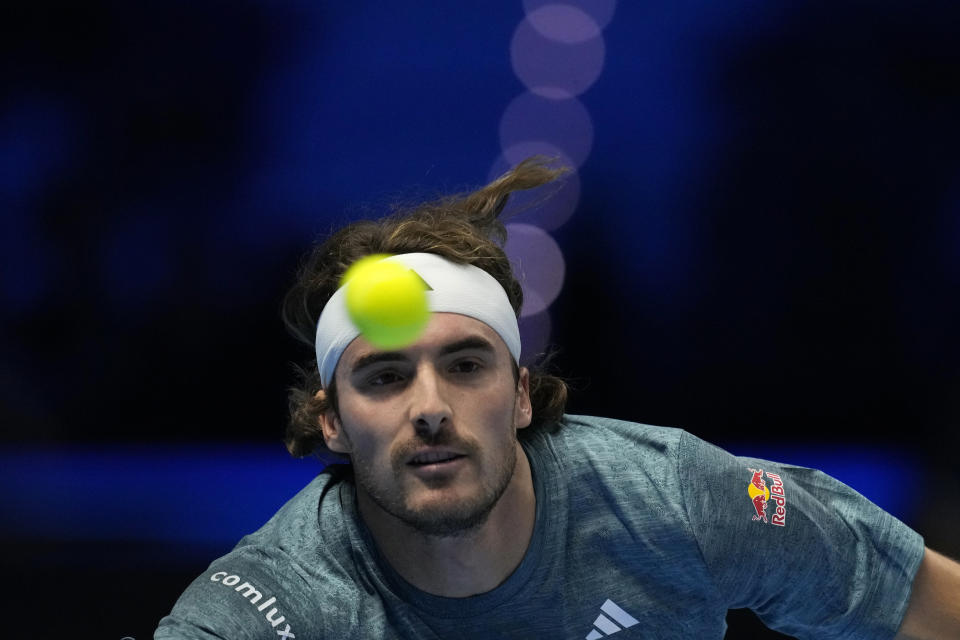 Greece's Stefanos Tsitsipas returns the ball to Italy's Jannik Sinner during their singles tennis match of the ATP World Tour Finals at the Pala Alpitour, in Turin, Italy, Sunday, Nov. 12, 2023. (AP Photo/Antonio Calanni)