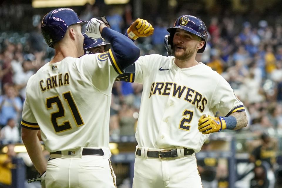 Milwaukee Brewers' Brice Turang is congratulated by Mark Canha (21) aftewr hitting a three-run home run during the fifth inning of a baseball game against the Pittsburgh Pirates Thursday, Aug. 3, 2023, in Milwaukee. (AP Photo/Morry Gash)