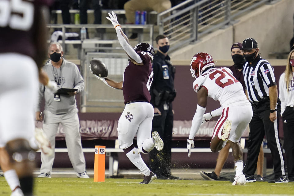 Texas A&M running back Ainias Smith (0) stays in bounds for a touchdown against Arkansas during the first quarter of an NCAA college football game Saturday, Oct. 31, 2020, in College Station, Texas. (AP Photo/Sam Craft)