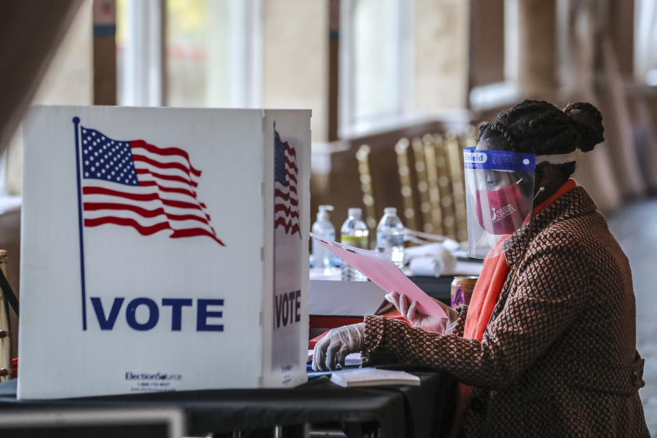 FILE - A poll worker sorts through voting material at Park Tavern in Atlanta, Tuesday, Nov. 3, 2020. (John Spink/Atlanta Journal-Constitution via AP, File)