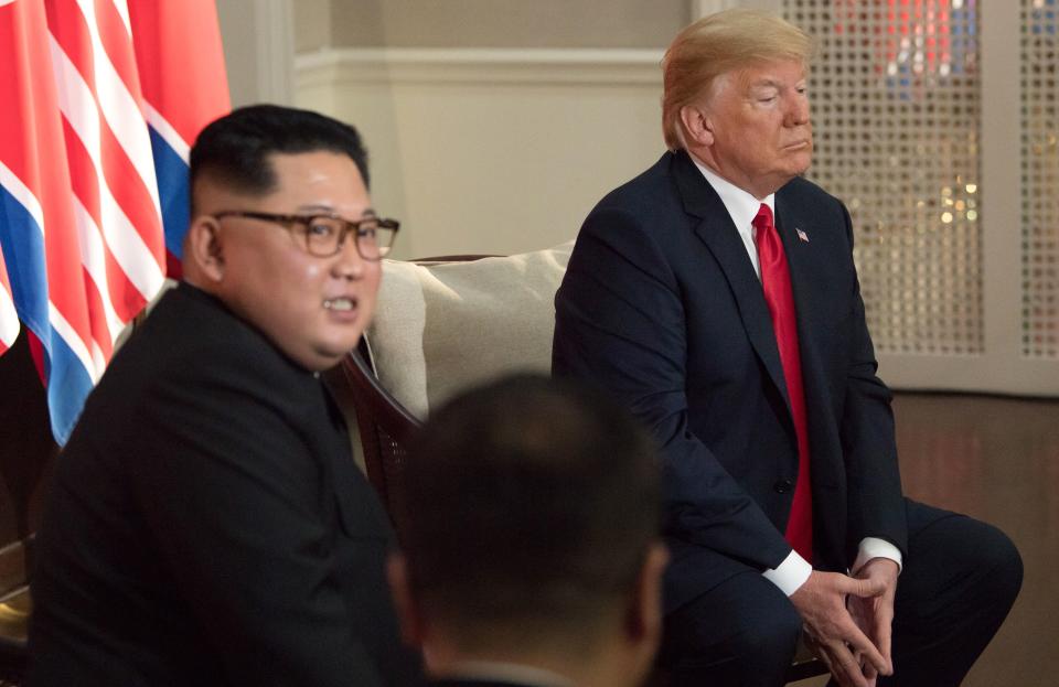 <p>North Korea’s leader Kim Jong Un (L) sits down with US President Donald Trump (R) their historic US-North Korea summit, at the Capella Hotel on Sentosa island in Singapore on June 12, 2018. (Photo: Saul Loeb/AFP/Getty Images) </p>