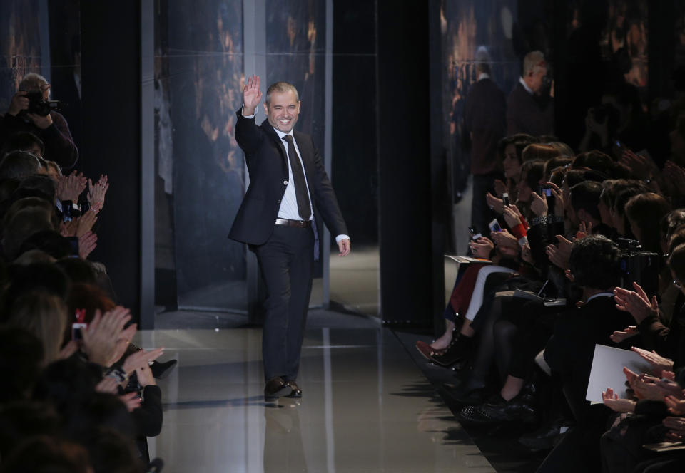 Lebanese fashion designer Elie Saab waves after his Spring Summer 2013 Haute Couture fashion collection, presented in Paris, Wednesday, Jan.23, 2013. (AP Photo/Christophe Ena)