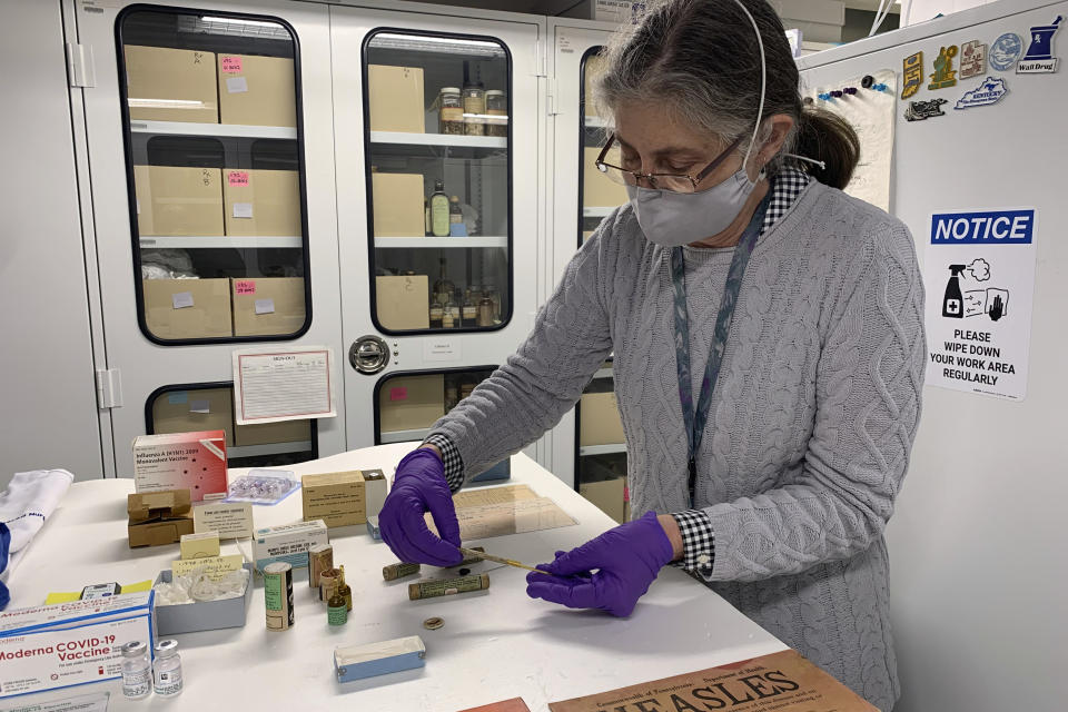 Diane Wendt, a curator at the Museum of American History, displays a small glass tube containing one of the original batches of polio vaccine on Monday, March 8, 2021, in Washington. The museum has acquired vials and material from the first dose of COVID-19 vaccine in the U.S. (AP Photo/Ashraf Khalil)