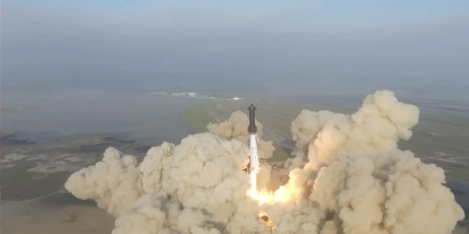 Starship black rocket lifts off from texas plains