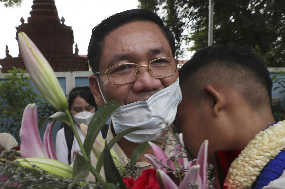 Thach Setha, left, a prominent vice president of the country's main opposition of Candlelight Party, hugs a boy in front of the Prey Sar main prison outside Phnom Penh, Cambodia, on Nov. 10, 2021. Thach Setha, a prominent leader of Cambodia’s political opposition, has been detained for allegedly issuing worthless checks, but his party said Tuesday, Jan. 17, 2023, the case is politically motivated. (AP Photo/Heng Sinith)