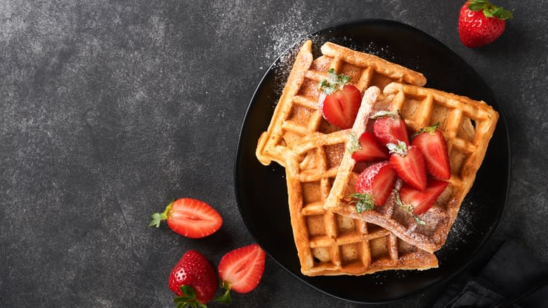 waffles strawberries black plate