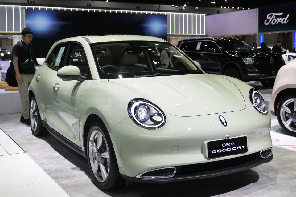 Visitors look at Great Wall Motor's electric vehicle "ORA Good Cat" during the 45th Bangkok Motor Show in Nonthaburi, Thailand, Tuesday, March 26, 2024. (AP Photo/Sakchai Lalit)