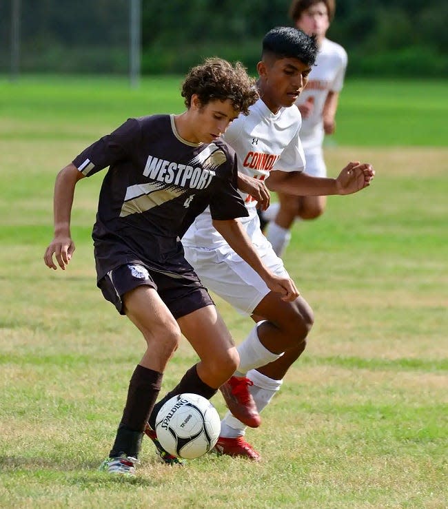 Bishop Connolly's Chris Guzman, right, battles with Westport's Ben Boudria during a recent game last month.