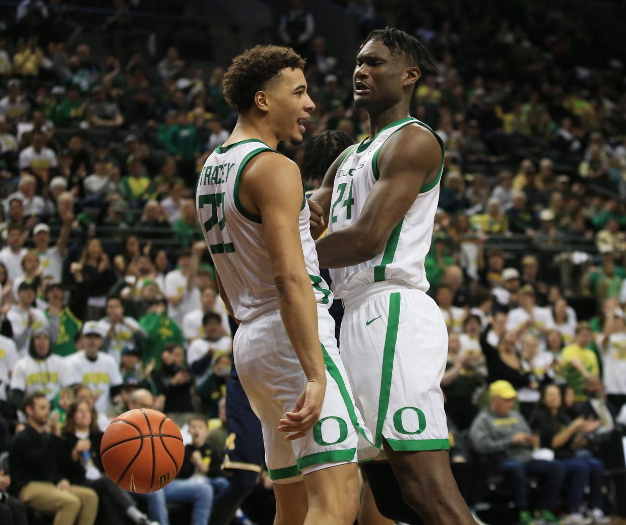 Oregon’s Jadrian Tracey left, and Mahamadou Diawara celebrate a play during their game against Michigan at Matthew Knight Arena in Eugene Saturday, Dec 2, 2023.