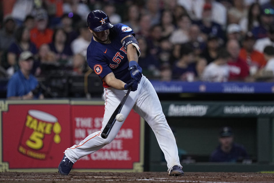 Houston Astros' Yainer Diaz hits an RBI double during the third inning of a baseball game against the Seattle Mariners, Sunday, Aug. 20, 2023, in Houston. (AP Photo/Kevin M. Cox)