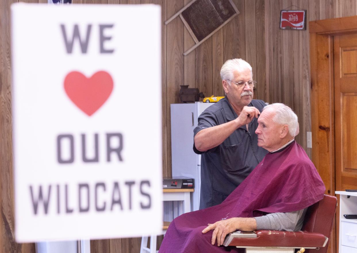 Marvin Harstine, who has been a barber for 52 years in Canton Township, provides a haircut on Tuesday for customer Howard Walters. Harstine is retiring June 1.