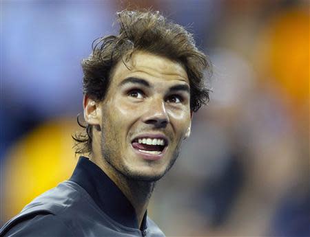 Rafael Nadal of Spain looks up at the crowd after defeating compatriot Tommy Robredo following their men's quarter-final match at the U.S. Open tennis championships in New York September 4, 2013. REUTERS/Adam Hunger