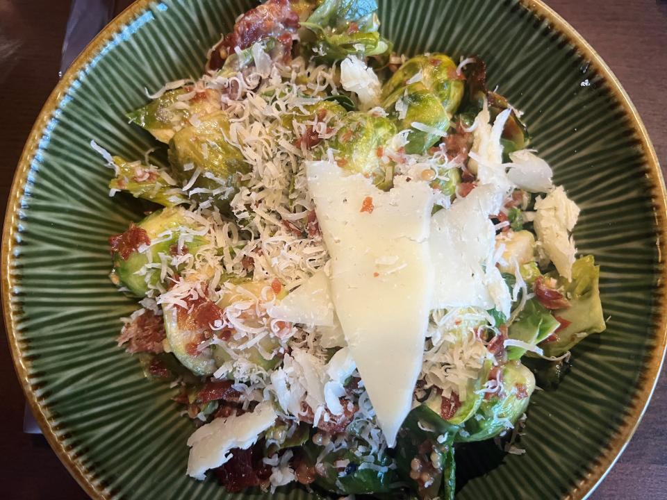 The famous Brussels sprouts at Table 128 feature prosciutto, Marcona almonds, Parmesan and shaved Manchego.