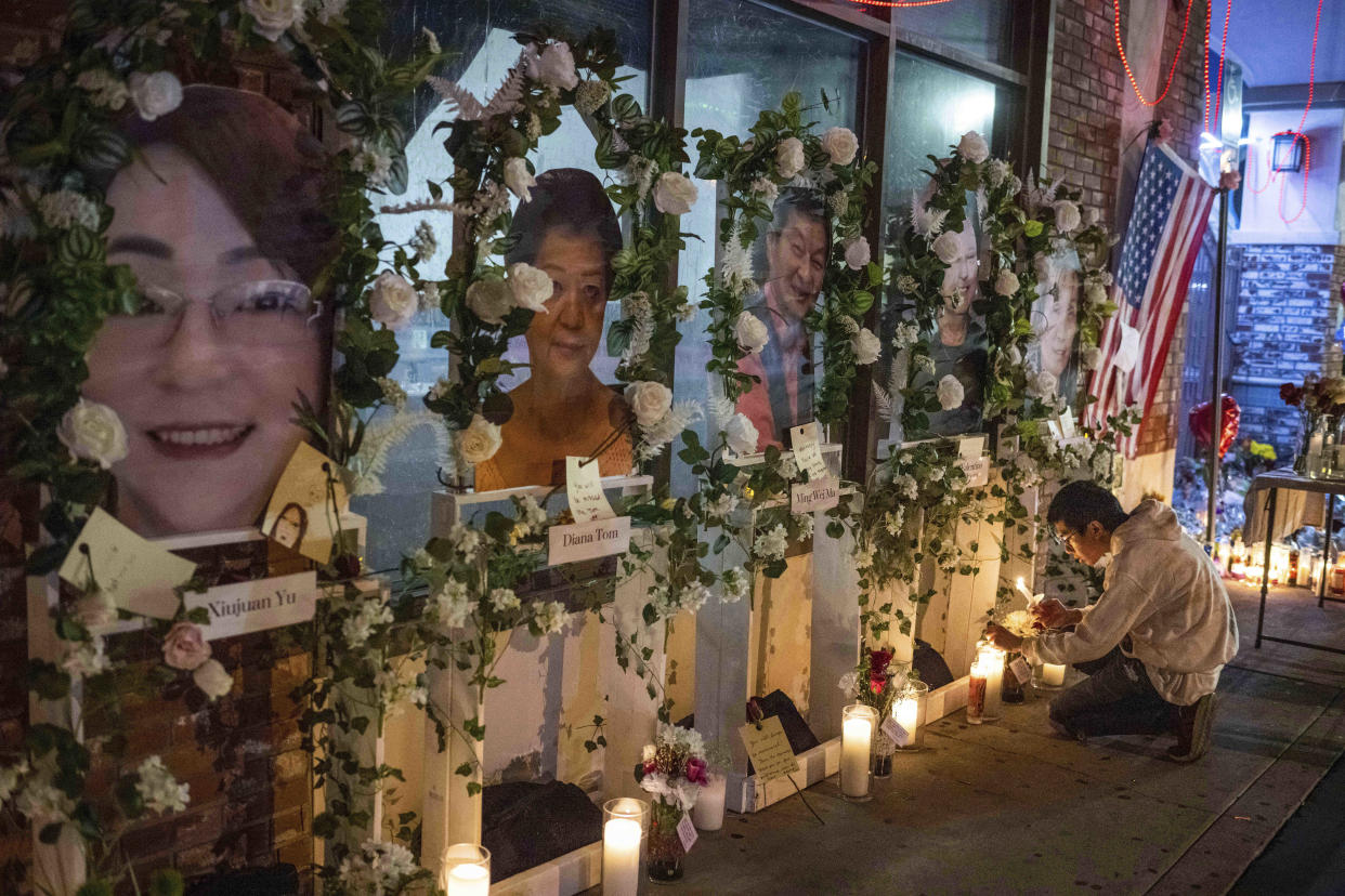 Eric Sham visits a makeshift memorial on Tuesday, Jan. 24, 2023 for those killed in a mass shooting at The Star Ballroom Dance Studio in Monterey Park. (Sarah Reingewirtz/The Orange County Register via AP)