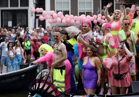 Participants cruise the canals in boats during the annual gay pride parade in Amsterdam