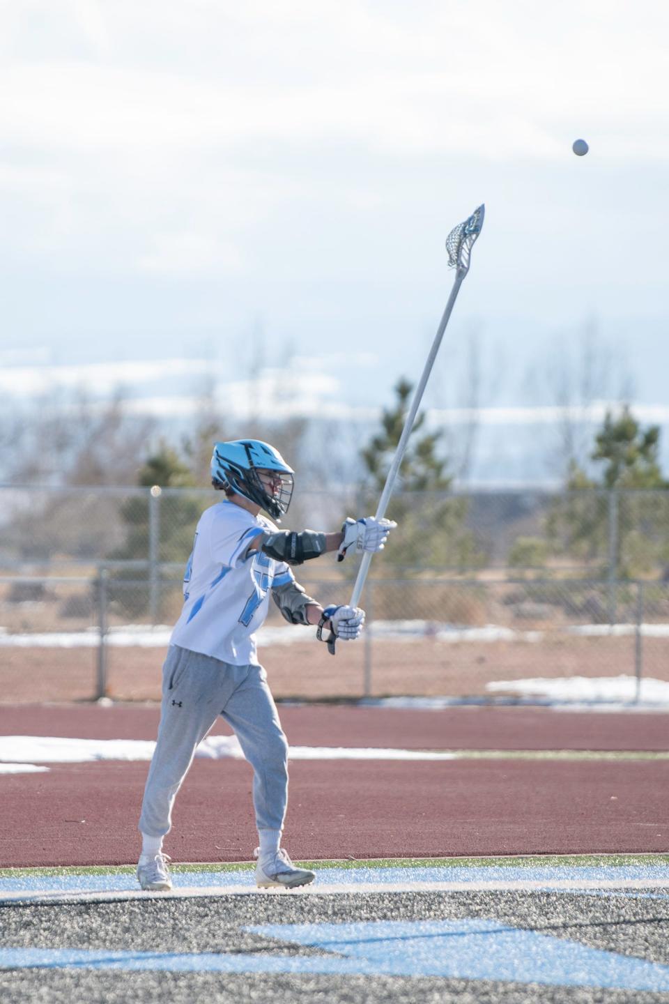 Pueblo West's Noah Dey fires off a pass during a game against Littleton on March 17.