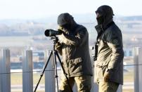 Two marksmen of the Police of the Canton of Zurich stand on an observation post at the airport in Zurich