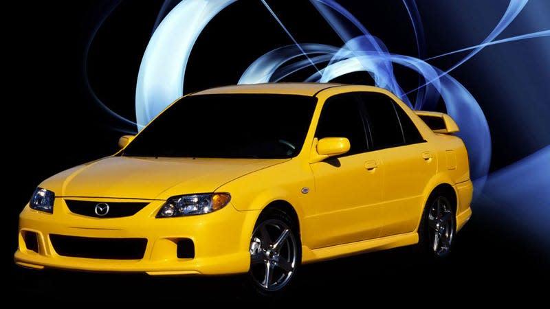 A photo of a yellow Mazda Speed Protege sedan. 