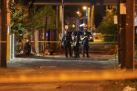 Police survey an area after a police officer was shot, Wednesday, Sept. 23, 2020, in Louisville, Ky. A grand jury has indicted one officer on criminal charges six months after Breonna Taylor was fatally shot by police in Kentucky. The jury presented its decision against fired officer Brett Hankison Wednesday to a judge in Louisville, where the shooting took place. (AP Photo/John Minchillo)