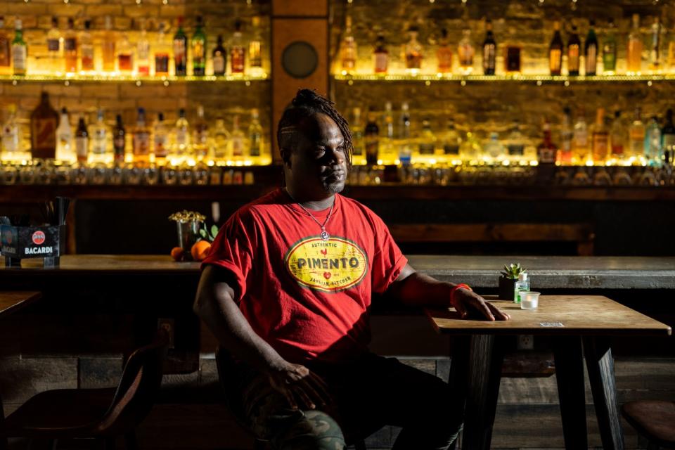 Tomme Beevas poses for a portrait at his restaurant, Pimento Jamaican Kitchen & Rum Bar.