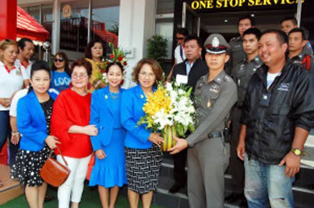 The Thai Tourism Board released this picture of the Tourism Minister for Hua Hin presenting police officers with flowers 