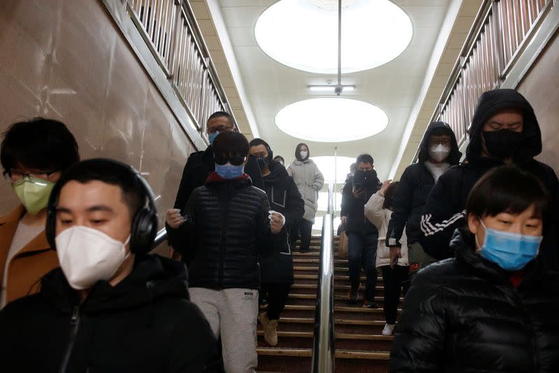 People wear face masks as they change subway lines in Beijing as the country is hit by an outbreak of the novel coronavirus