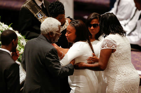 REFILE - ADDITIONAL CAPTION INFORMATIONKeirra LaNae Scott (C), daughter of police shooting victim Keith Scott, mourns with family members during his funeral at the First Baptist Church in James Island, South Carolina, U.S. October 14, 2016. REUTERS/Randall Hill