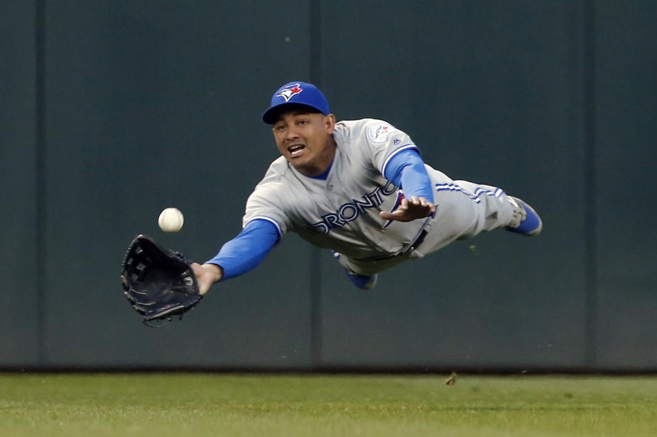 <p>Toronto Blue Jays center fielder Ezequiel Carrera makes a diving catch to rob Minnesota Twins’ Trevor Plouffe of a hit in the fourth inning of a baseball game, May 20, 2016, in Minneapolis. (Jim Mone/AP) </p>
