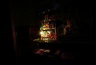 Sweets for sale are seen inside a store lit by candlelight after a massive blackout in Argentina, in Montevideo