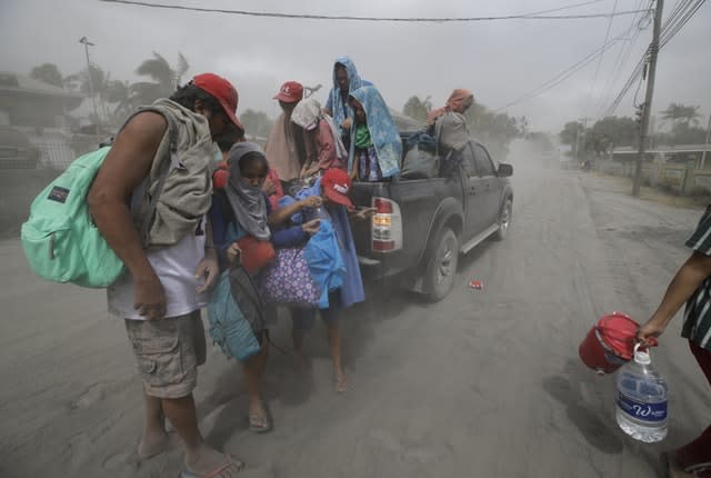A family evacuates to safer grounds as Taal volcano in Tagaytay, Cavite province, southern Philippines