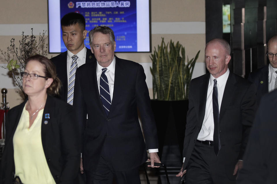 U.S. Trade Representative Robert Lighthizer, center, and his deputy Jeffrey D. Gerrish, right, leave a hotel in Beijing, Friday, March 29, 2019. U.S. trade negotiators lead by Treasury Secretary Steven Mnuchin and Lighthizer arrived in Beijing to start a new round of talks aimed at ending a tariff war over China's technology ambitions as officials hint they might be making progress. (AP Photo/Andy Wong)