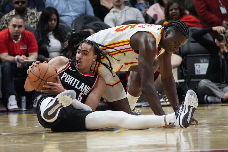 Portland Trail Blazers guard Dalano Banton (5) comes up with a loose ball against Atlanta Hawks center Clint Capela (15) during the first half of an NBA basketball game Wednesday, March 27, 2024, in Atlanta. (AP Photo/John Bazemore)