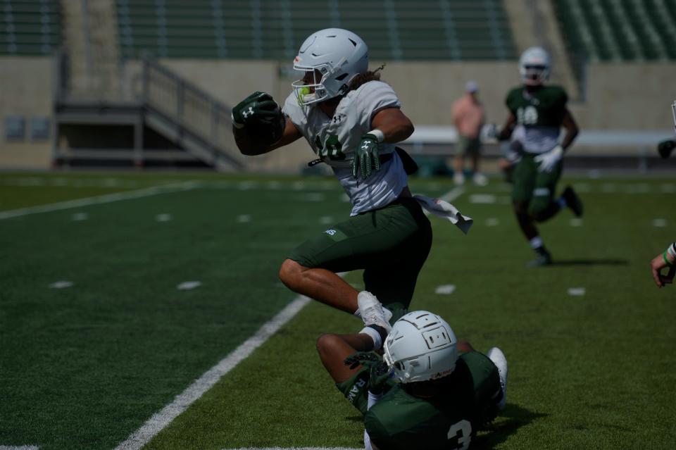 Colorado State football player Vince Brown runs over a defender during an exhibition game on Wednesday, August 7, 2024.