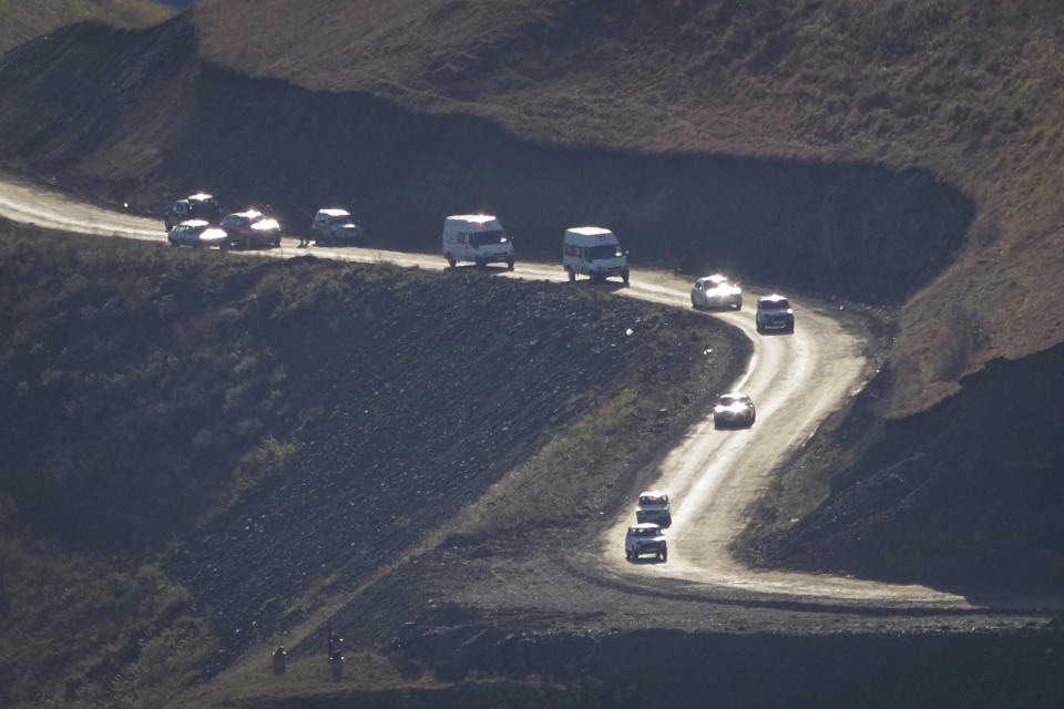 Cars with people leaving the separatist region of Nagorno-Karabakh to Armenia approach the border of Armenia, Sunday, Nov. 8, 2020. (AP Photo)